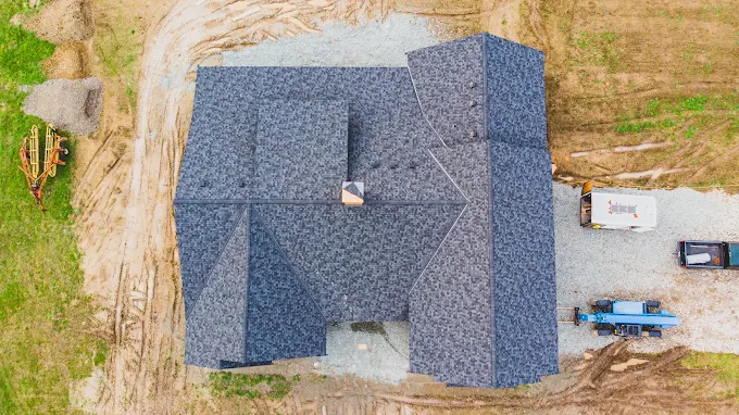 Aerial view of a new charcoal architectural shingle roof on a new-construction home